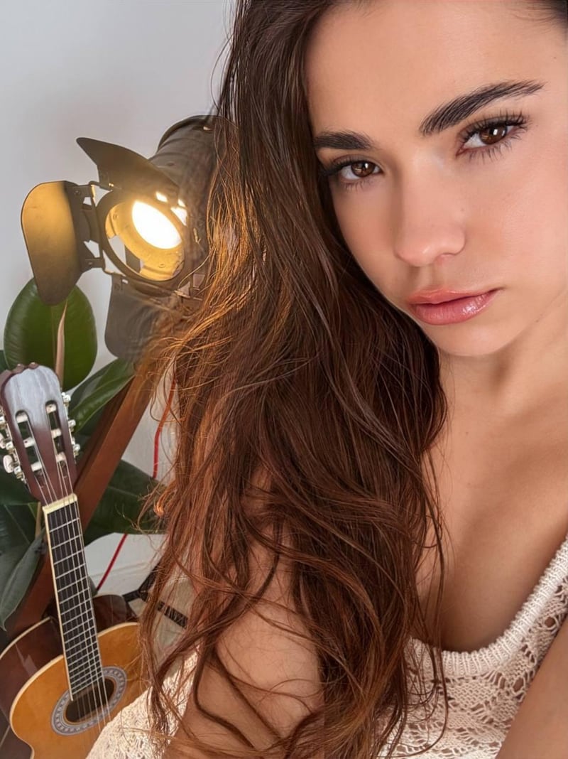 Lisa taking a selfie next to a guitar